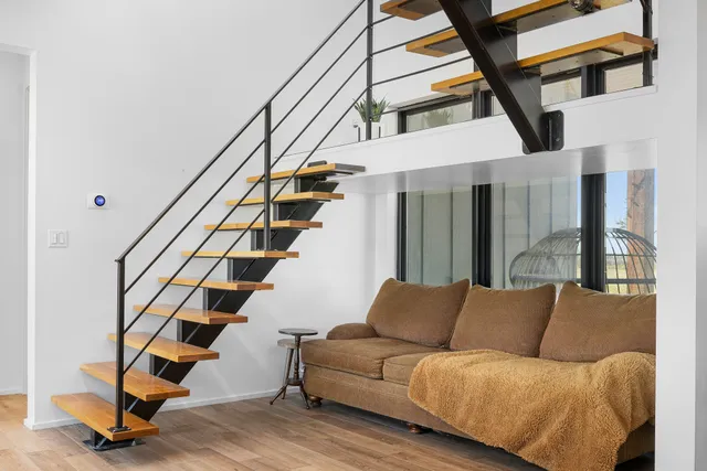 a living room with furniture and a ceiling fan
