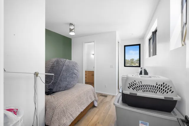 a bedroom with a bed and a window