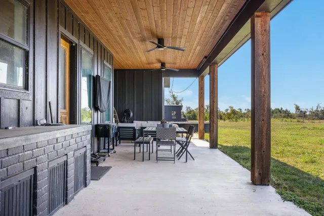 a dining room with furniture and a floor to ceiling window