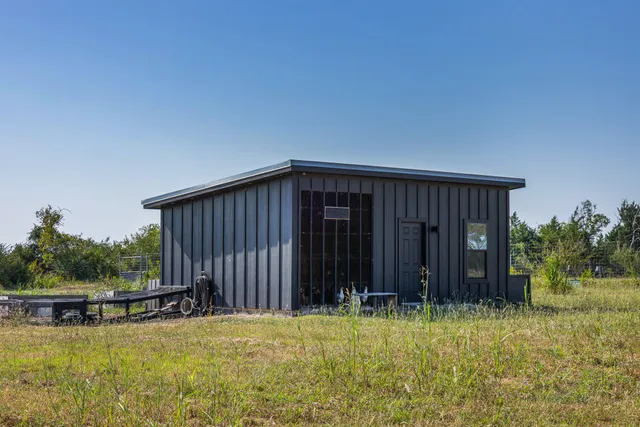 a view of a house with backyard and sitting area