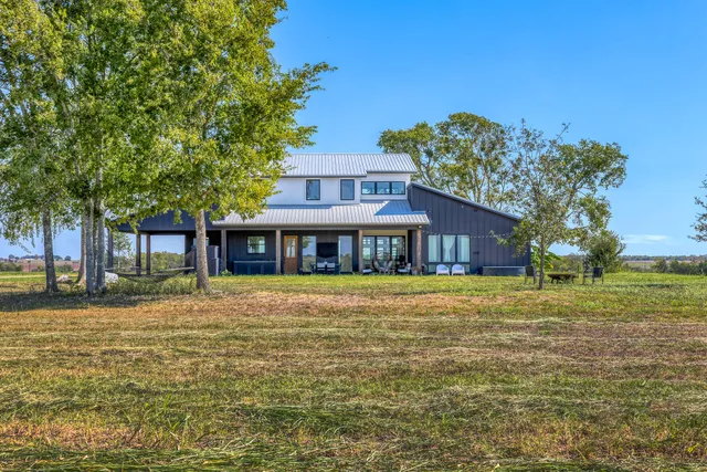 a front view of a house with a big yard