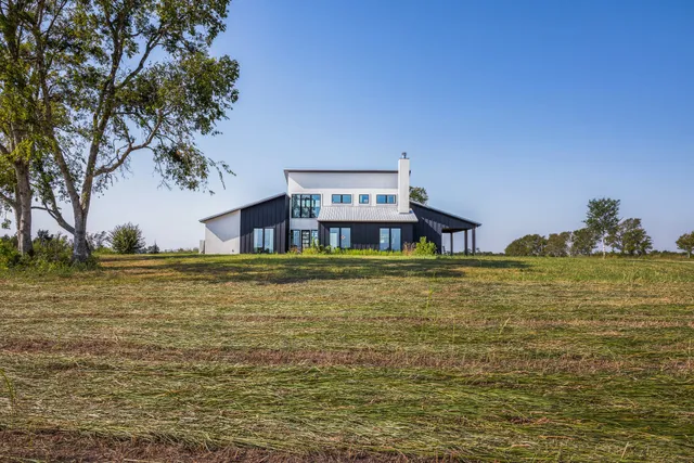 a house view with swimming pool