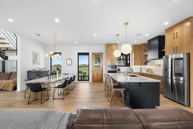a large kitchen with a table and chairs