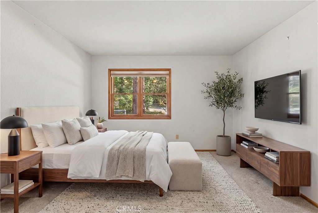 25455 Tahquitz Road Idyllwild, CA 92549 - Photo 15 of 25 a bedroom with a bed and a flat screen tv