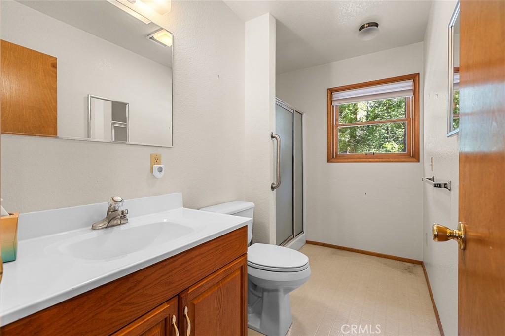 25455 Tahquitz Road Idyllwild, CA 92549 - Photo 16 of 25 a bathroom with a sink a toilet and shower