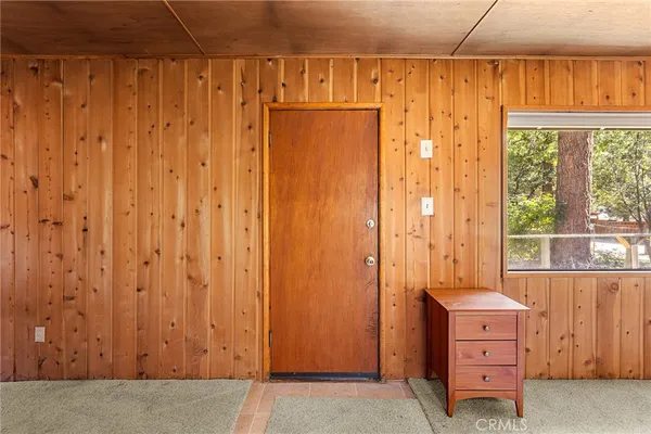 a view of a utility room with a door and a window