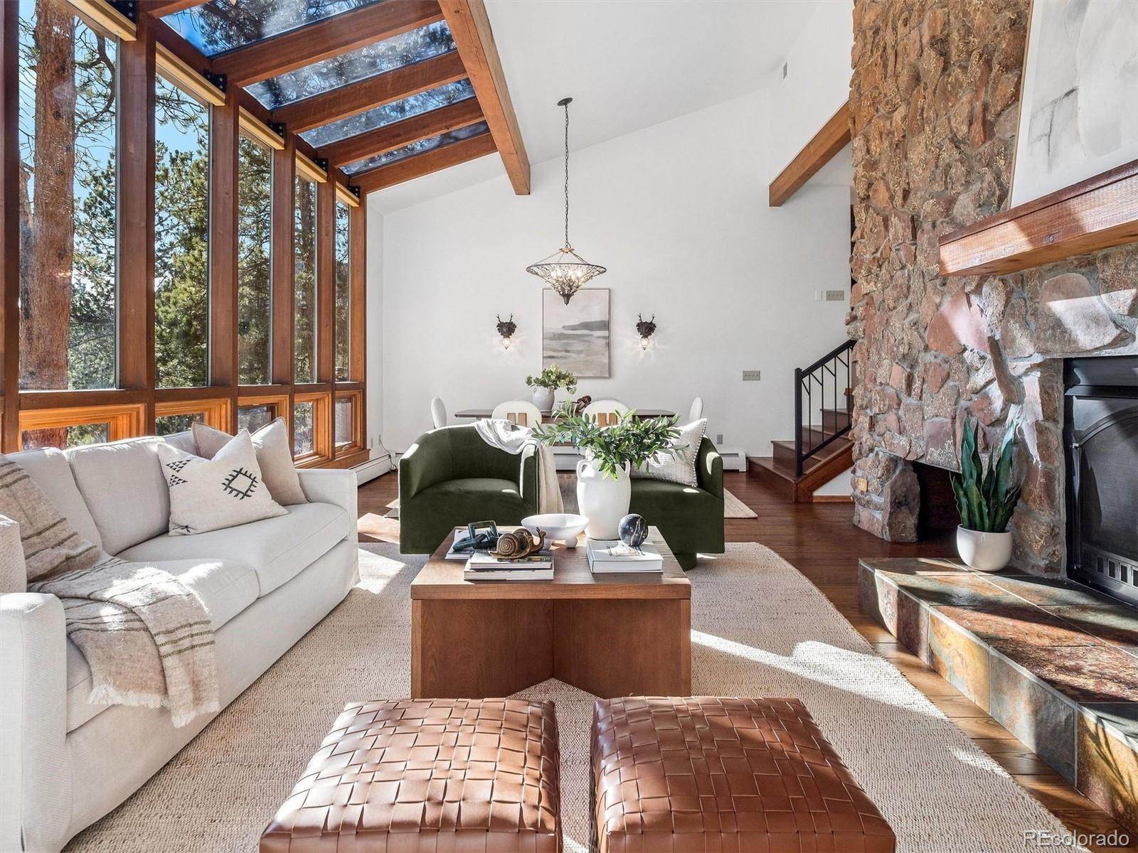 a living room with furniture flowerpot and a chandelier