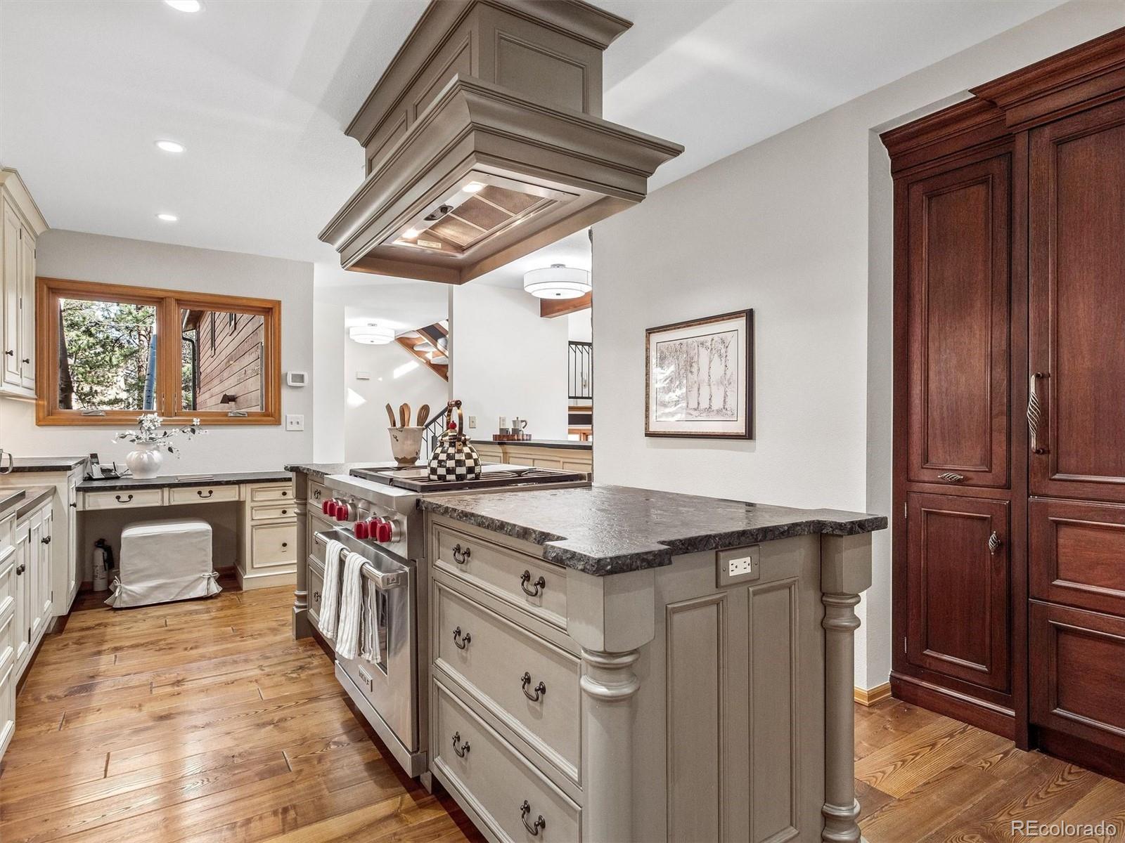 67 Oak Way Evergreen, CO 80439 - Photo 11 of 44 a kitchen with stainless steel appliances granite countertop a stove and a sink