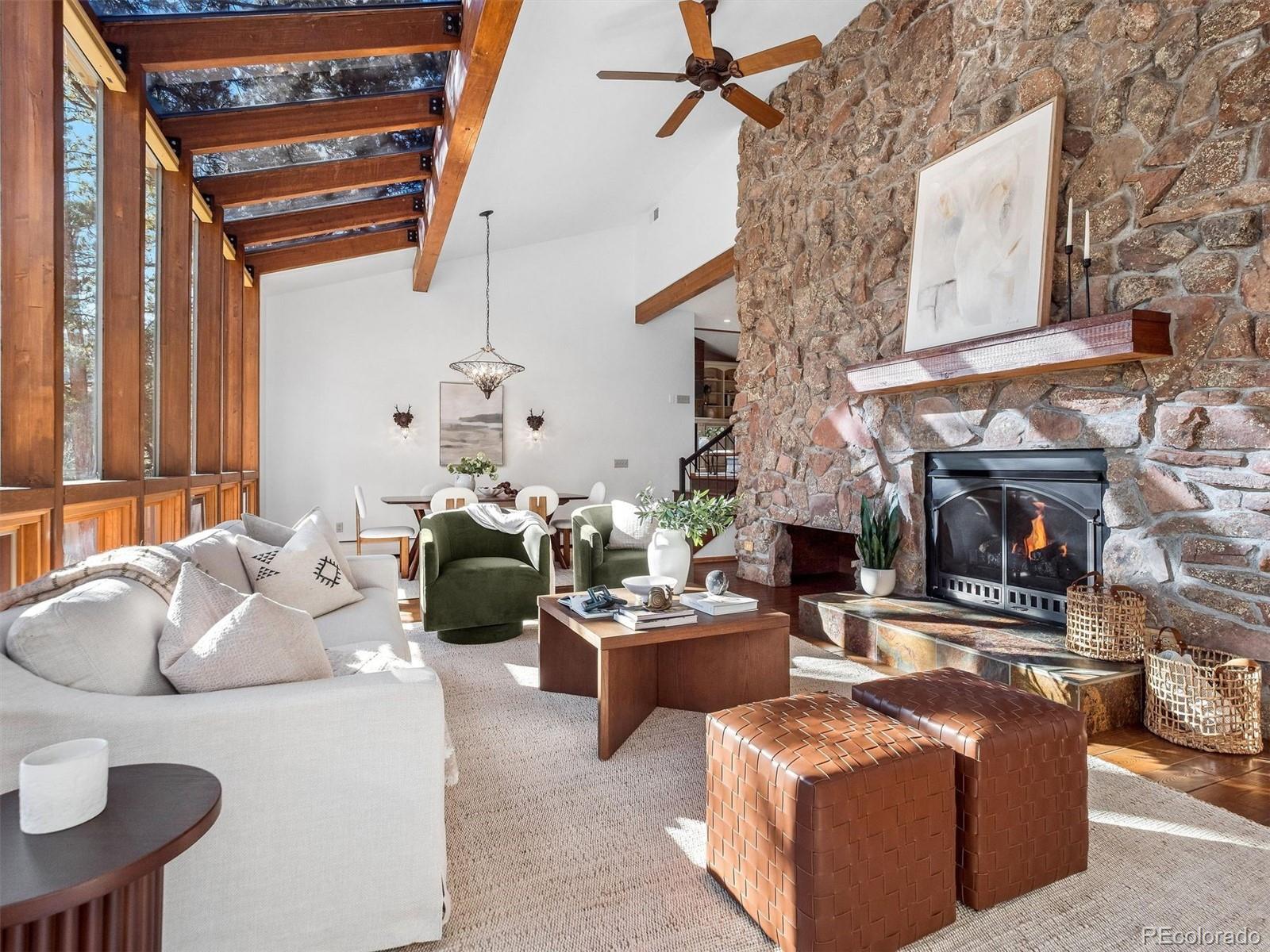 67 Oak Way Evergreen, CO 80439 - Photo 17 of 44 a living room with furniture and a fireplace