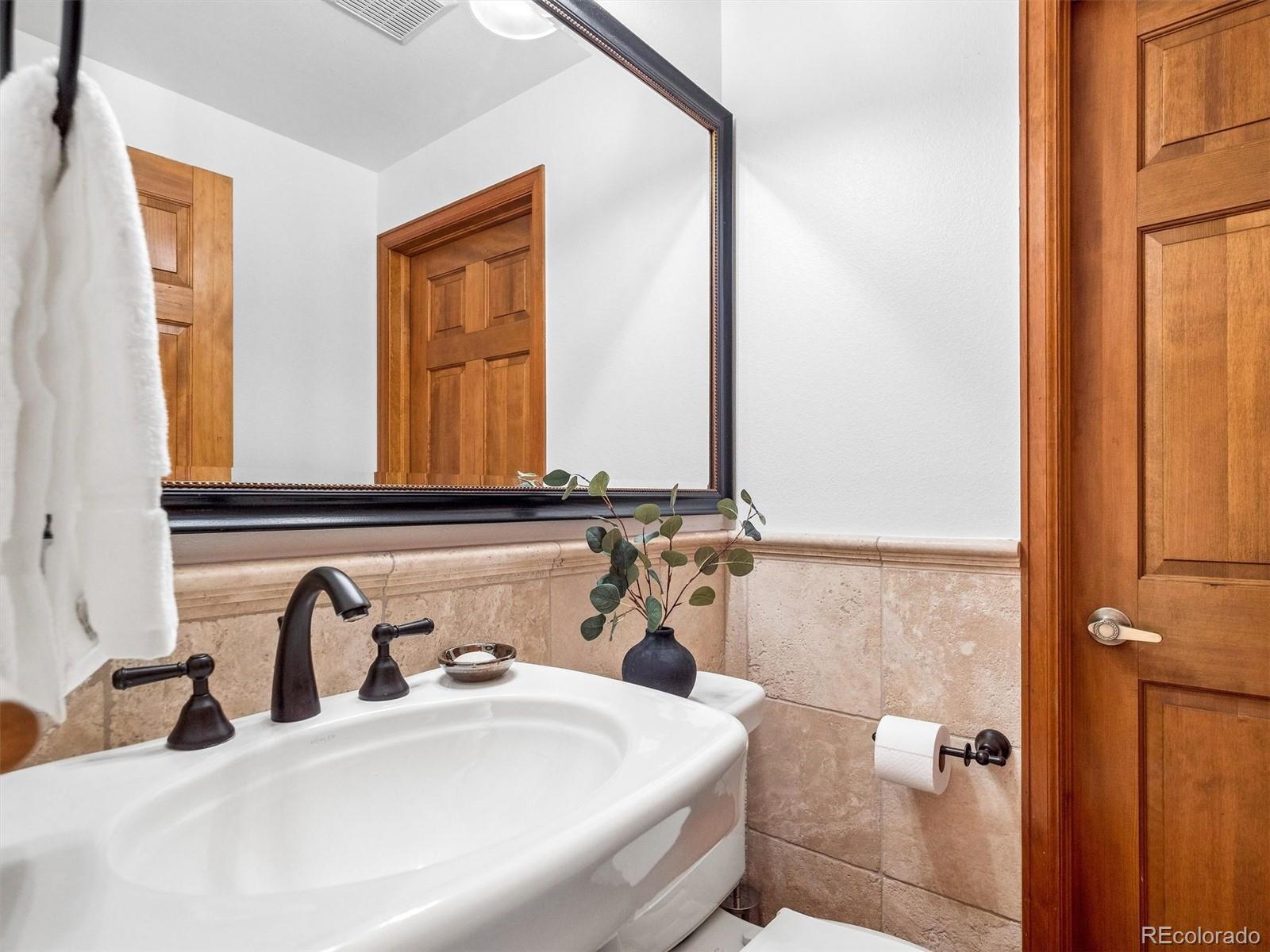 67 Oak Way Evergreen, CO 80439 - Photo 24 of 44 a bathroom with a sink and a mirror