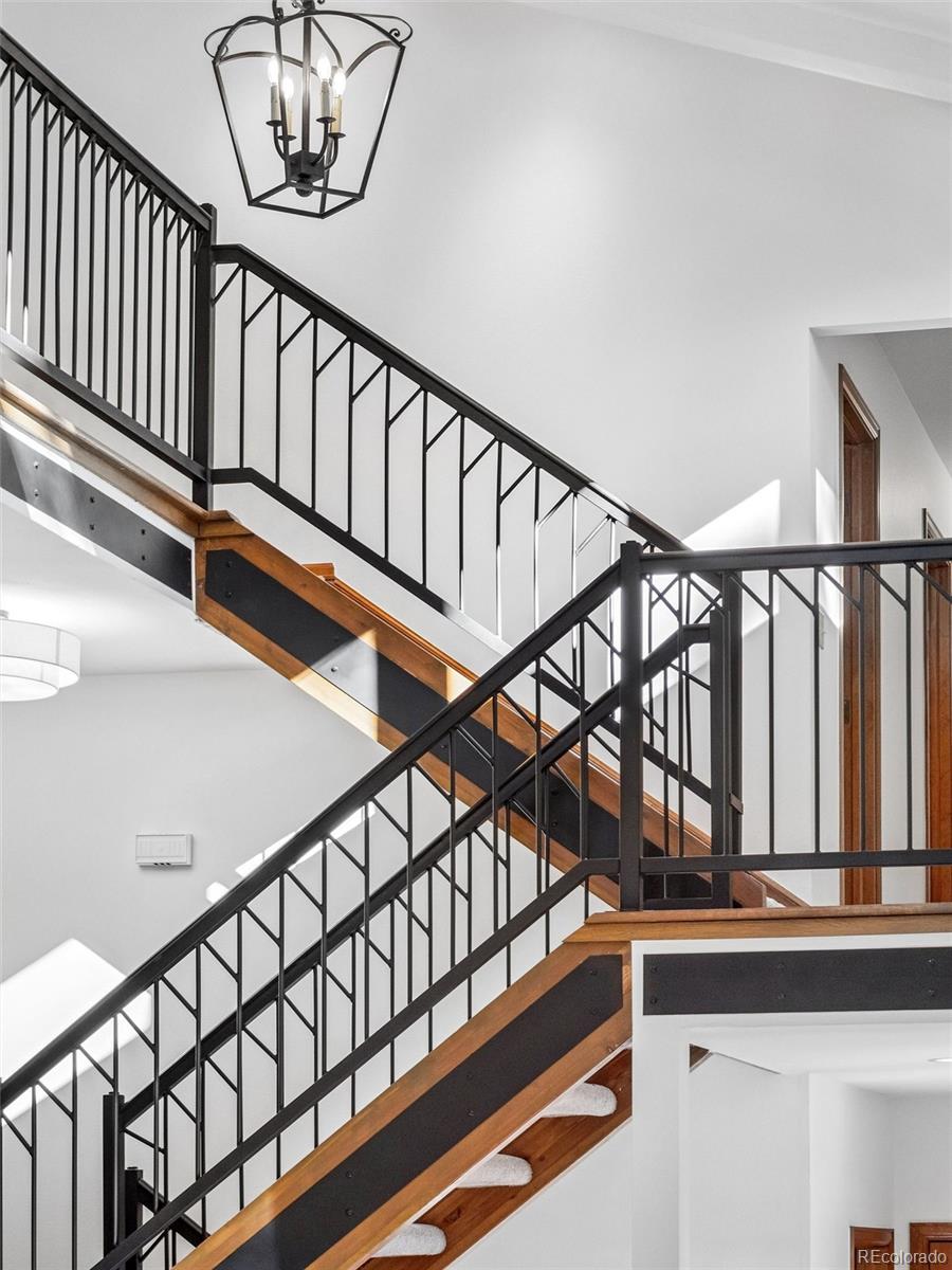 67 Oak Way Evergreen, CO 80439 - Photo 25 of 44 a view of staircase with lots of frames on wall