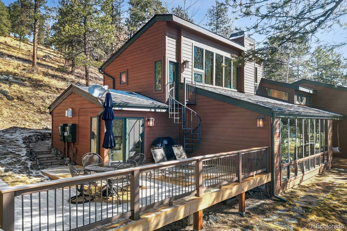 67 Oak Way Evergreen, CO 80439 - Photo 31 of 44 a view of a house with large windows