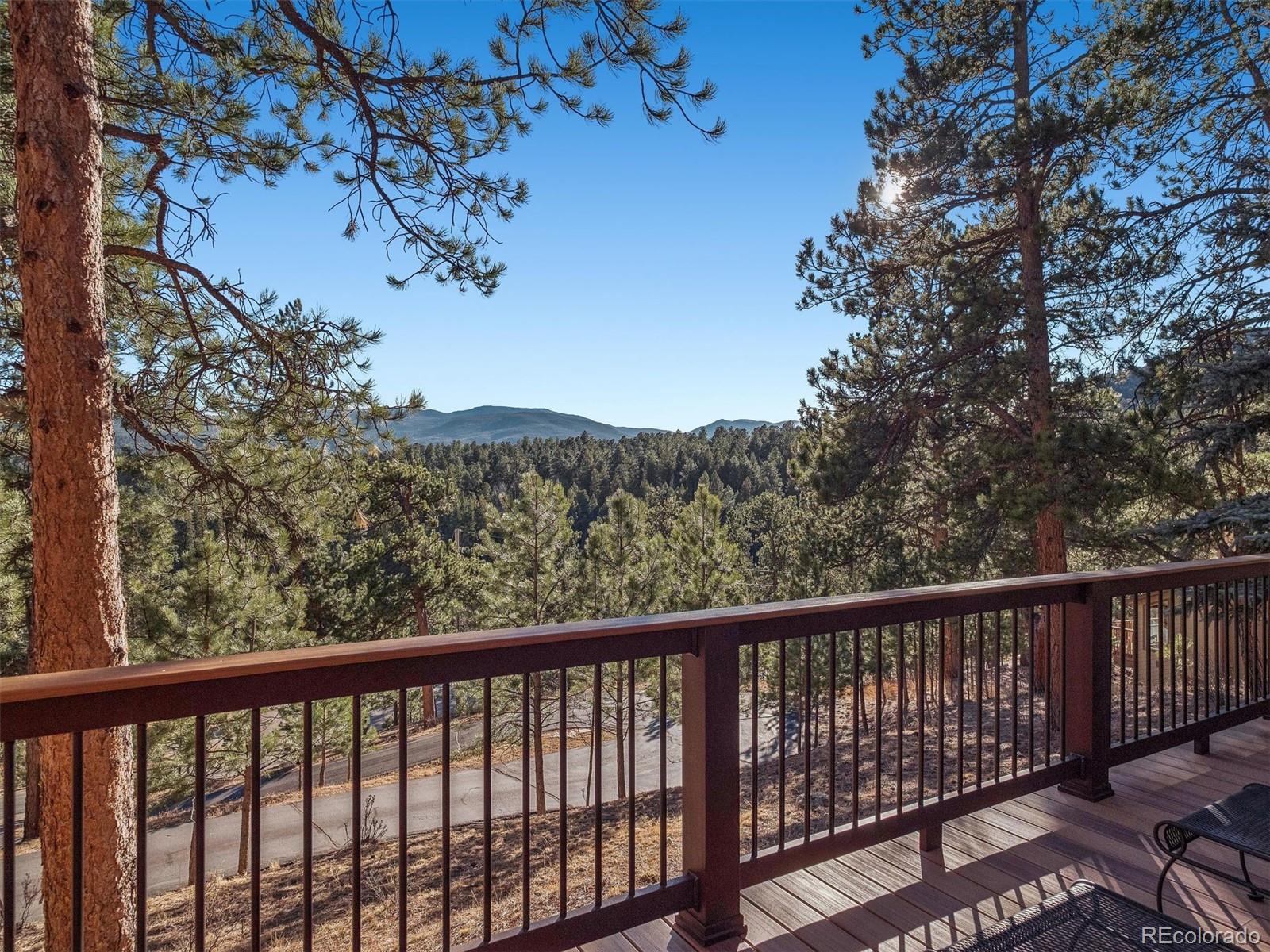 67 Oak Way Evergreen, CO 80439 - Photo 33 of 44 a view of a balcony with wooden fence and floor