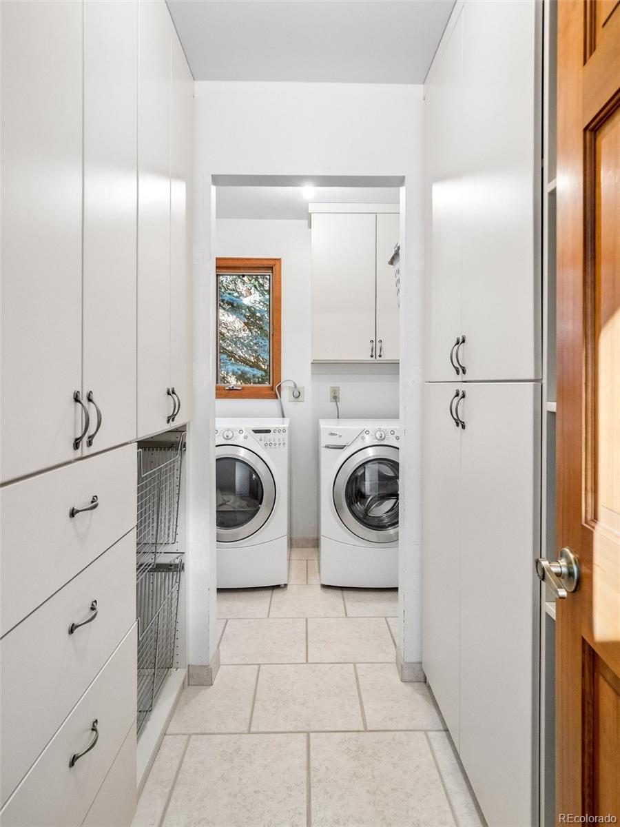 67 Oak Way Evergreen, CO 80439 - Photo 38 of 44 a view of a storage and utility room with washer and dryer