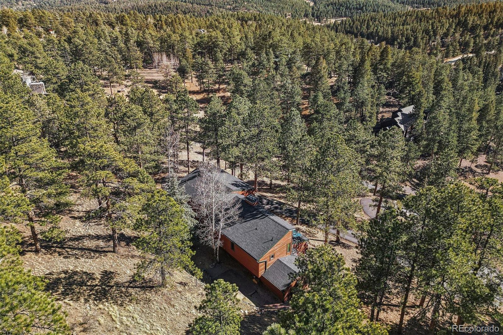 67 Oak Way Evergreen, CO 80439 - Photo 40 of 44 an aerial view of a house with a yard
