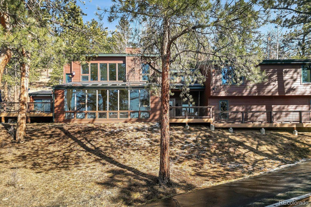 67 Oak Way Evergreen, CO 80439 - Photo 4 of 44 a front view of a house with a yard