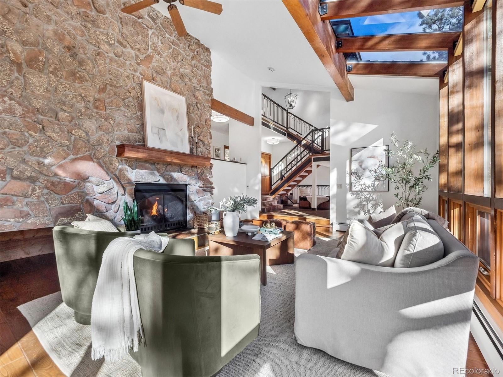 67 Oak Way Evergreen, CO 80439 - Photo 5 of 44 a living room with fireplace furniture and a potted plant