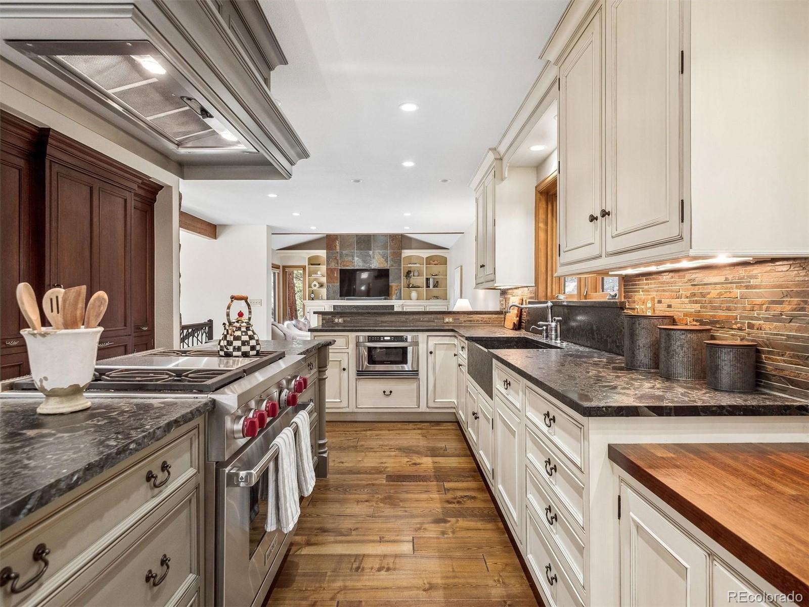 67 Oak Way Evergreen, CO 80439 - Photo 6 of 44 a kitchen with stainless steel appliances granite countertop a stove and a sink