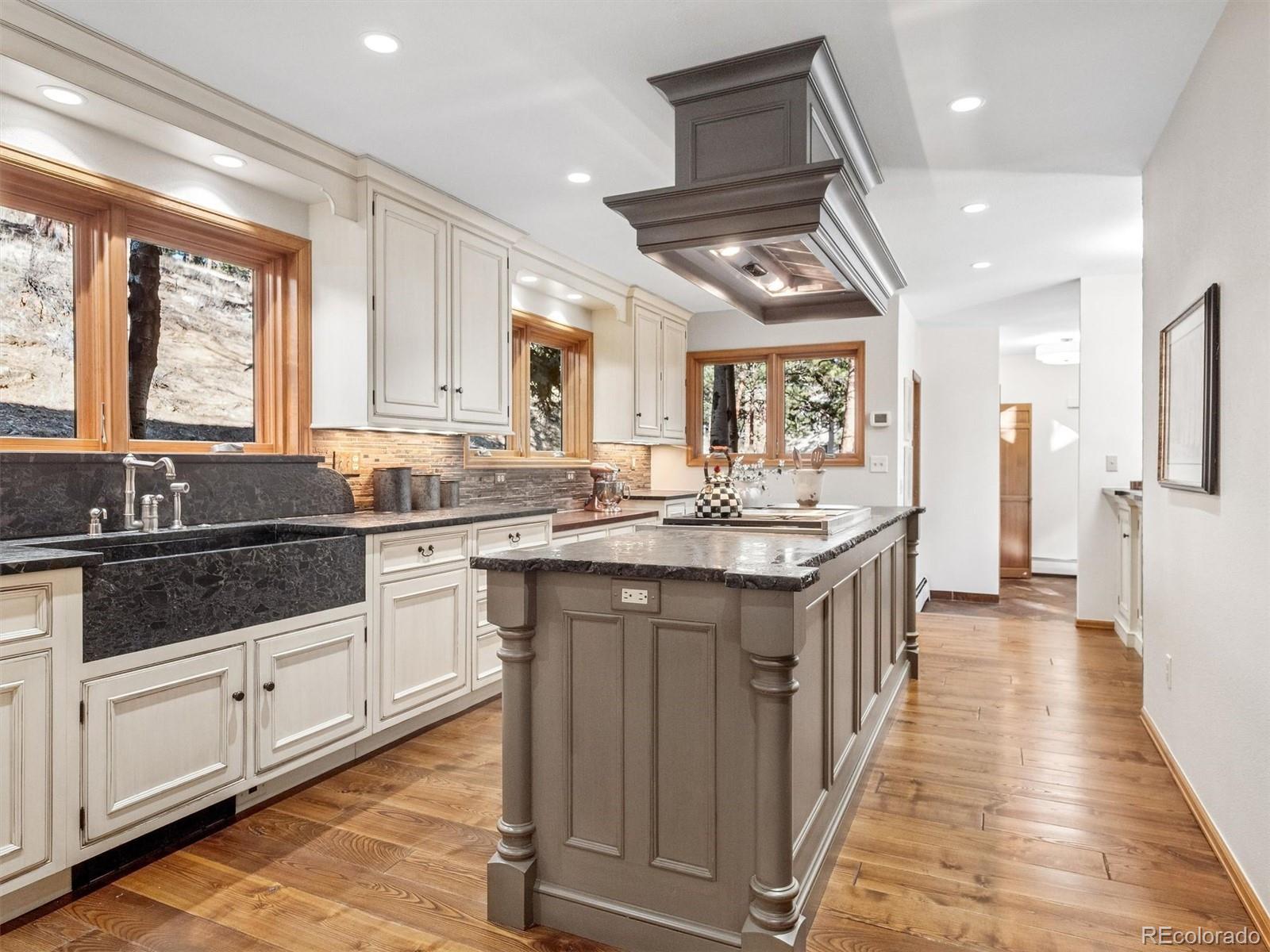 67 Oak Way Evergreen, CO 80439 - Photo 8 of 44 a kitchen with granite countertop a sink stove and cabinets