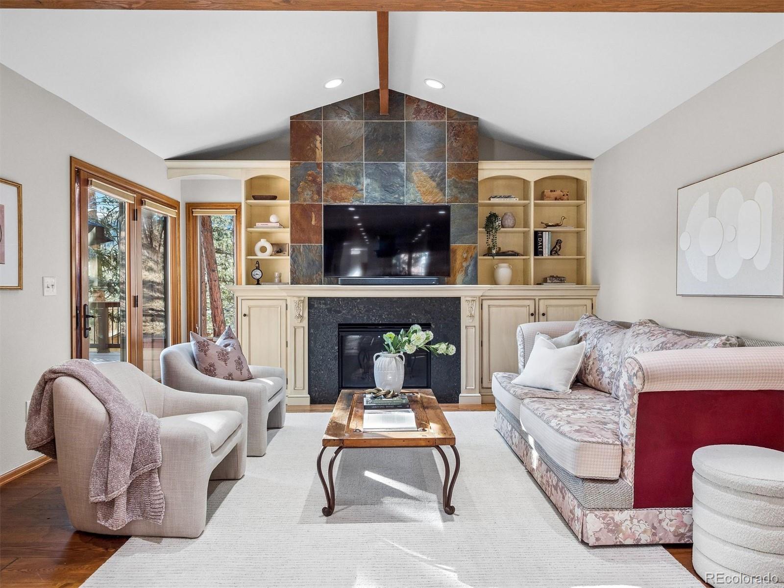 67 Oak Way Evergreen, CO 80439 - Photo 9 of 44 a living room with furniture and a fireplace