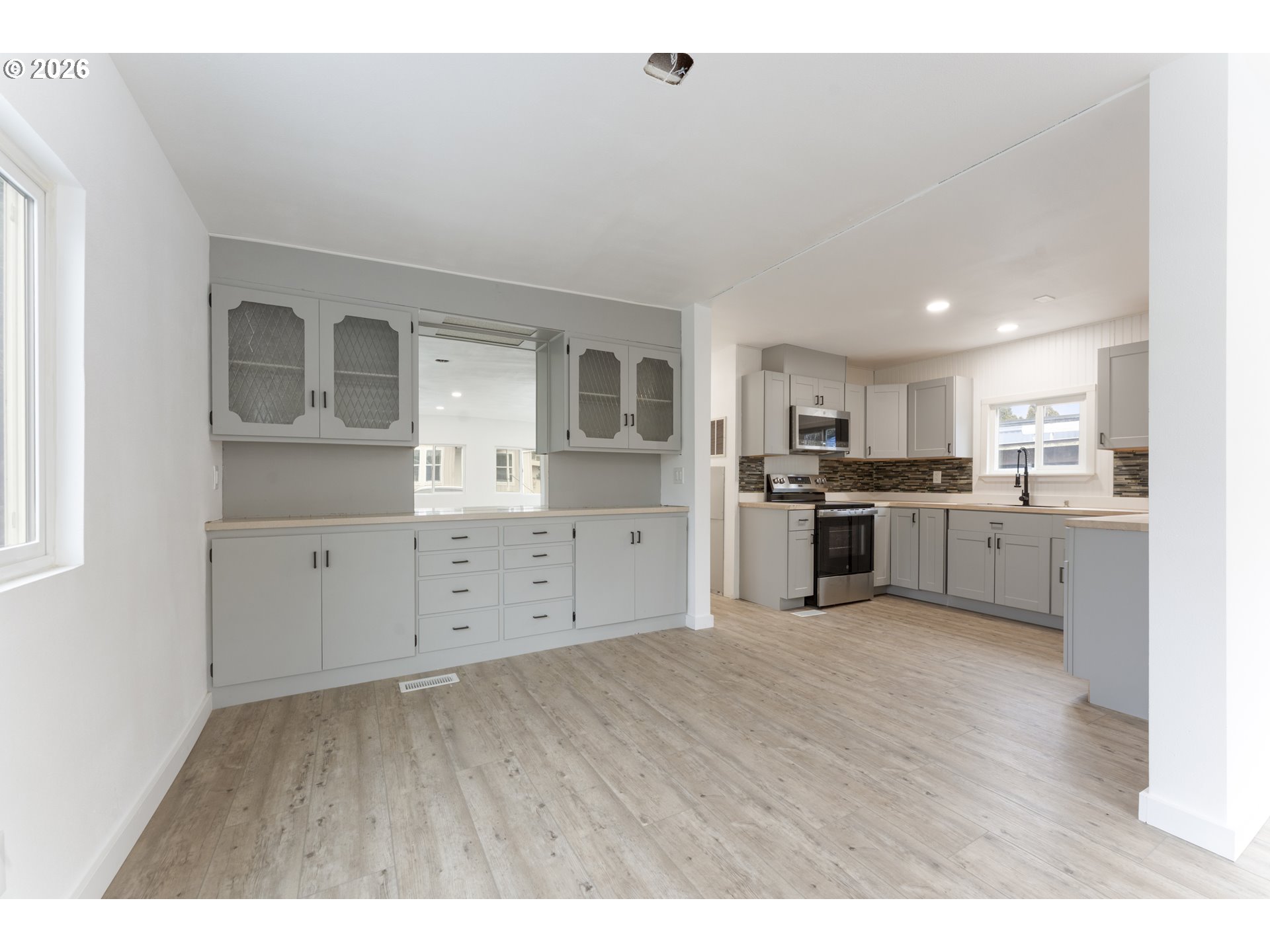 4424 Southeast Roethe Road, Unit 3 Milwaukie, OR 97267 - Photo 11 of 30 a kitchen with stainless steel appliances a refrigerator sink and cabinets