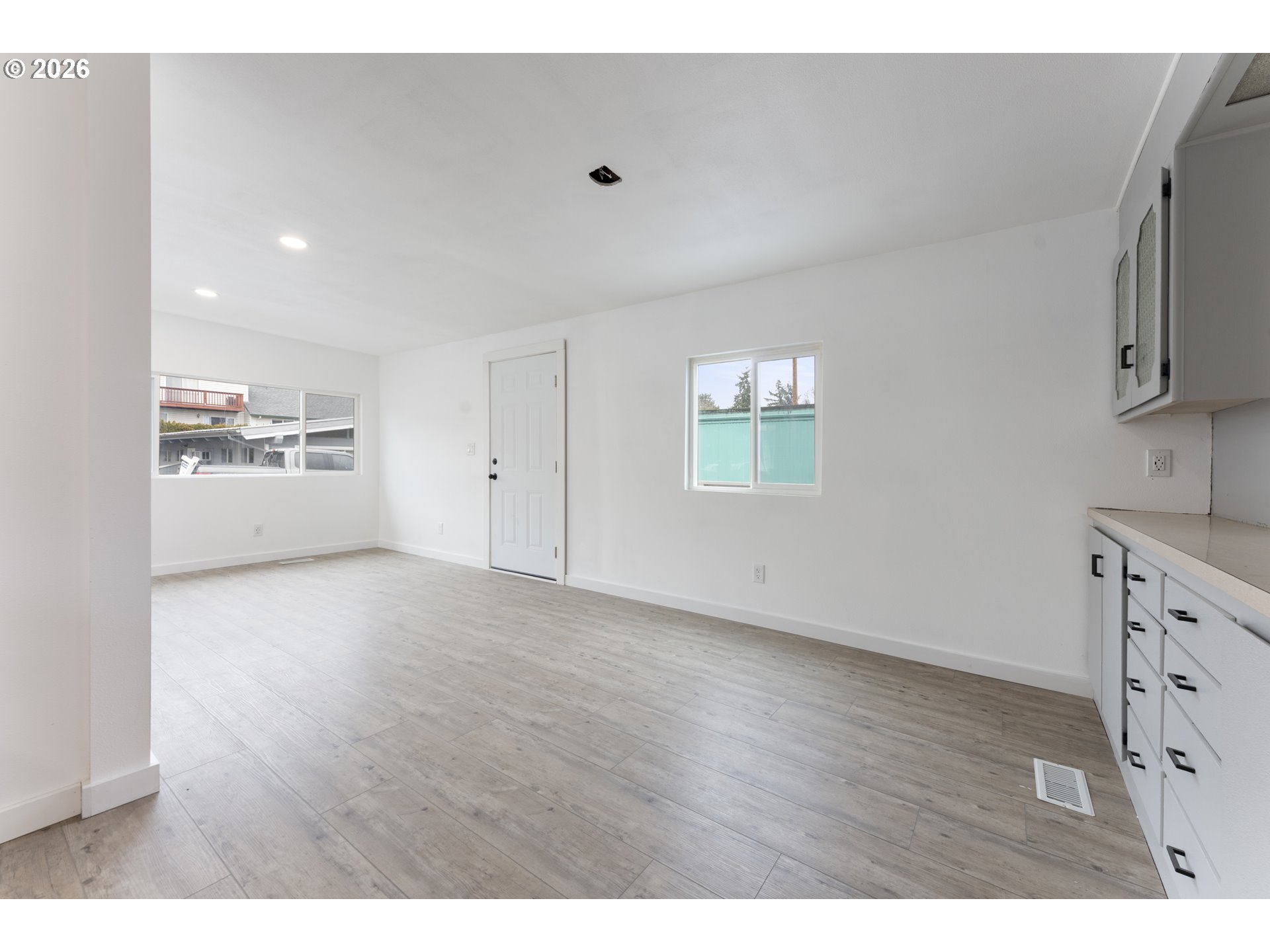 4424 Southeast Roethe Road, Unit 3 Milwaukie, OR 97267 - Photo 12 of 30 a view of an empty room with a window and wooden floor
