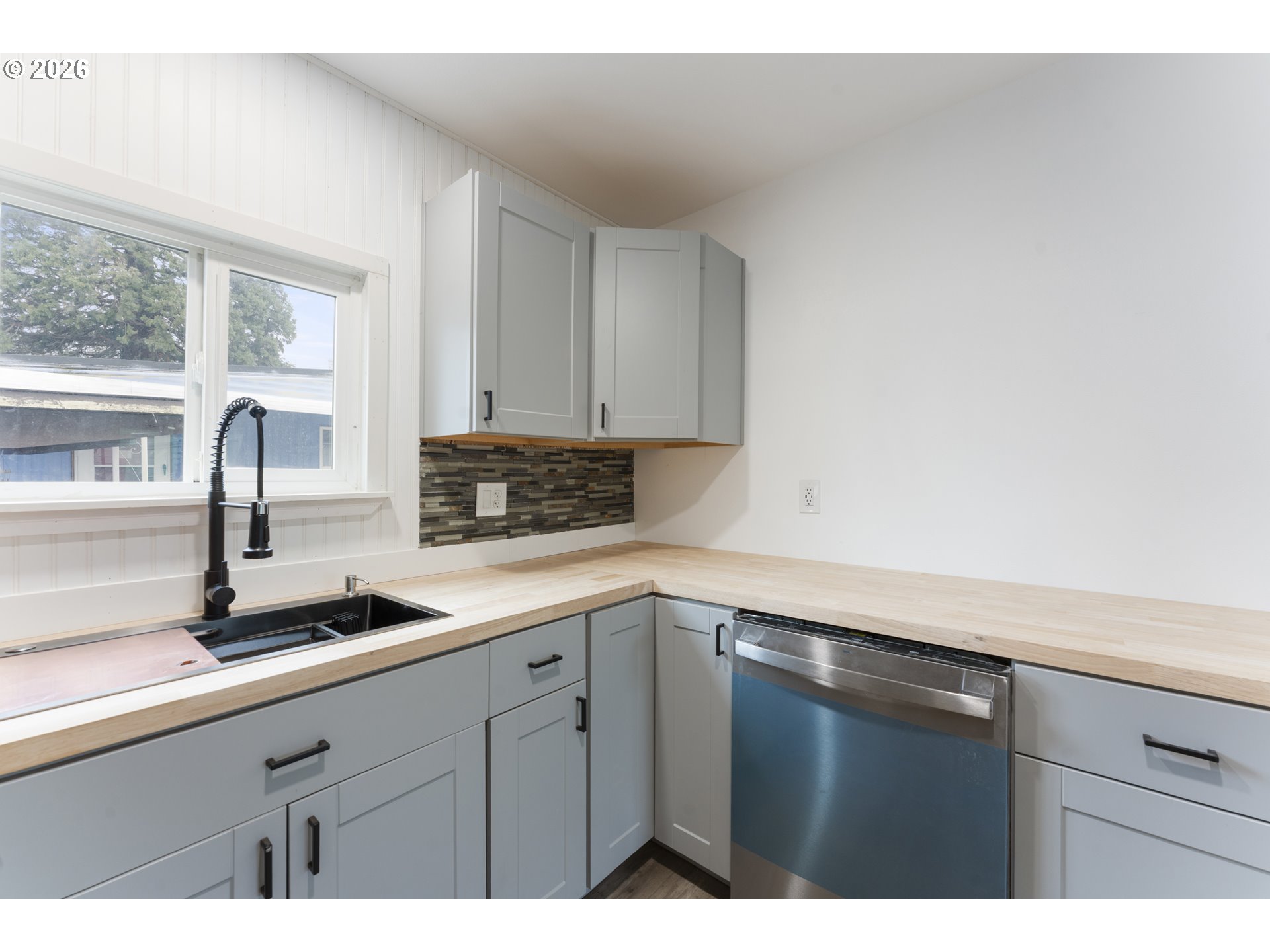 4424 Southeast Roethe Road, Unit 3 Milwaukie, OR 97267 - Photo 14 of 30 a kitchen with a sink and cabinets