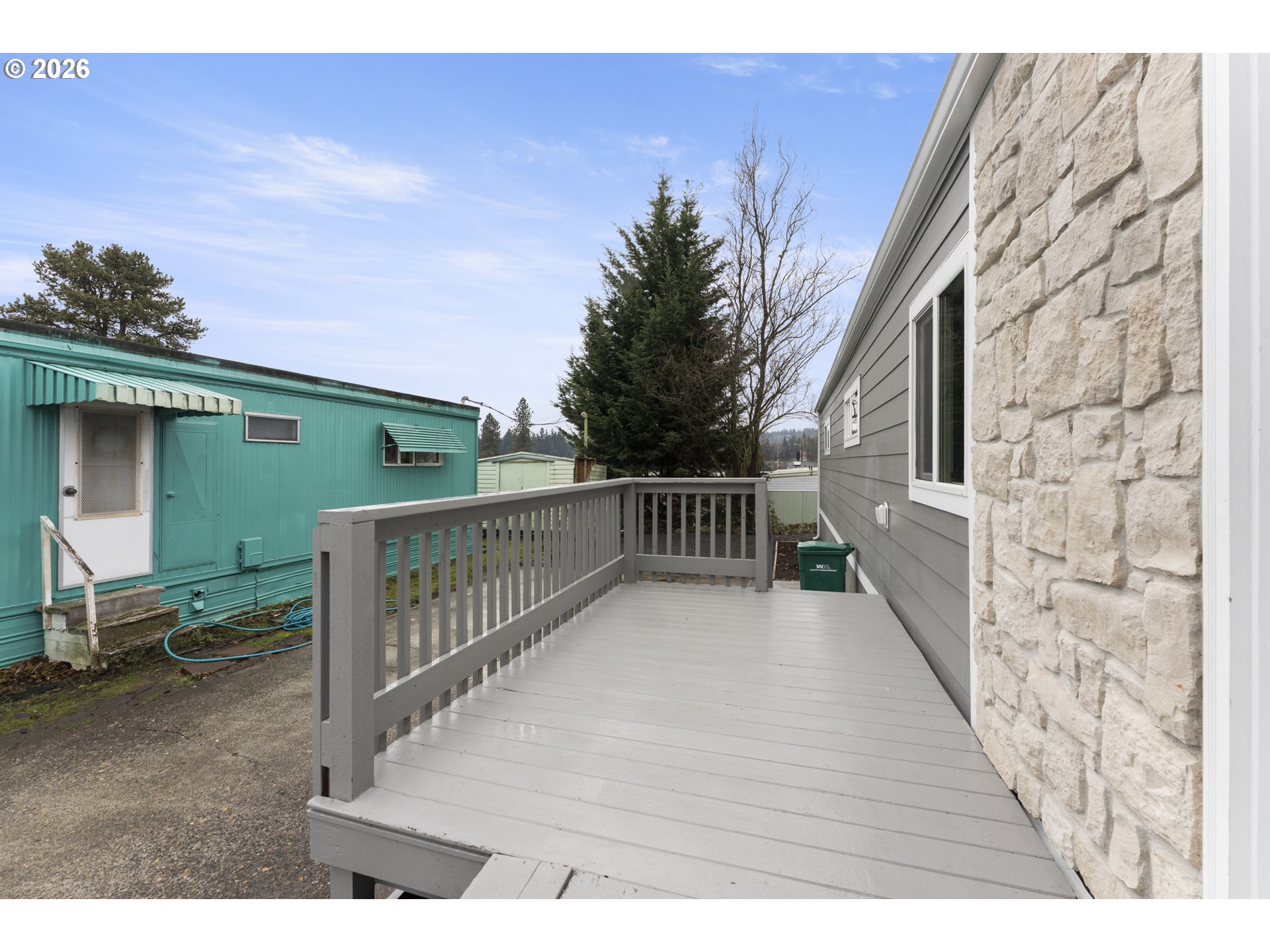 4424 Southeast Roethe Road, Unit 3 Milwaukie, OR 97267 - Photo 4 of 30 a balcony with wooden floor and fence