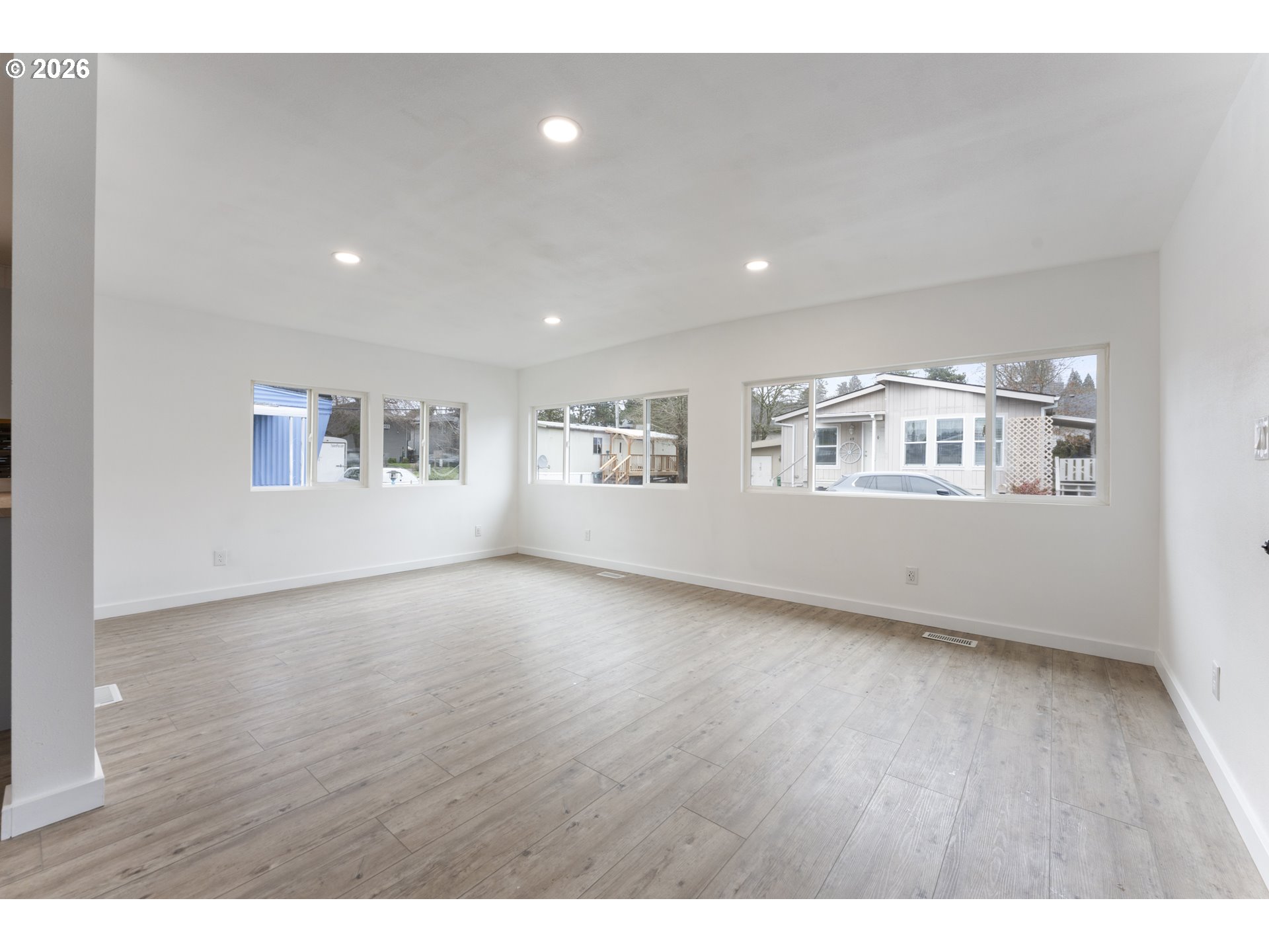 4424 Southeast Roethe Road, Unit 3 Milwaukie, OR 97267 - Photo 7 of 30 a view of an empty room with a window and wooden floor