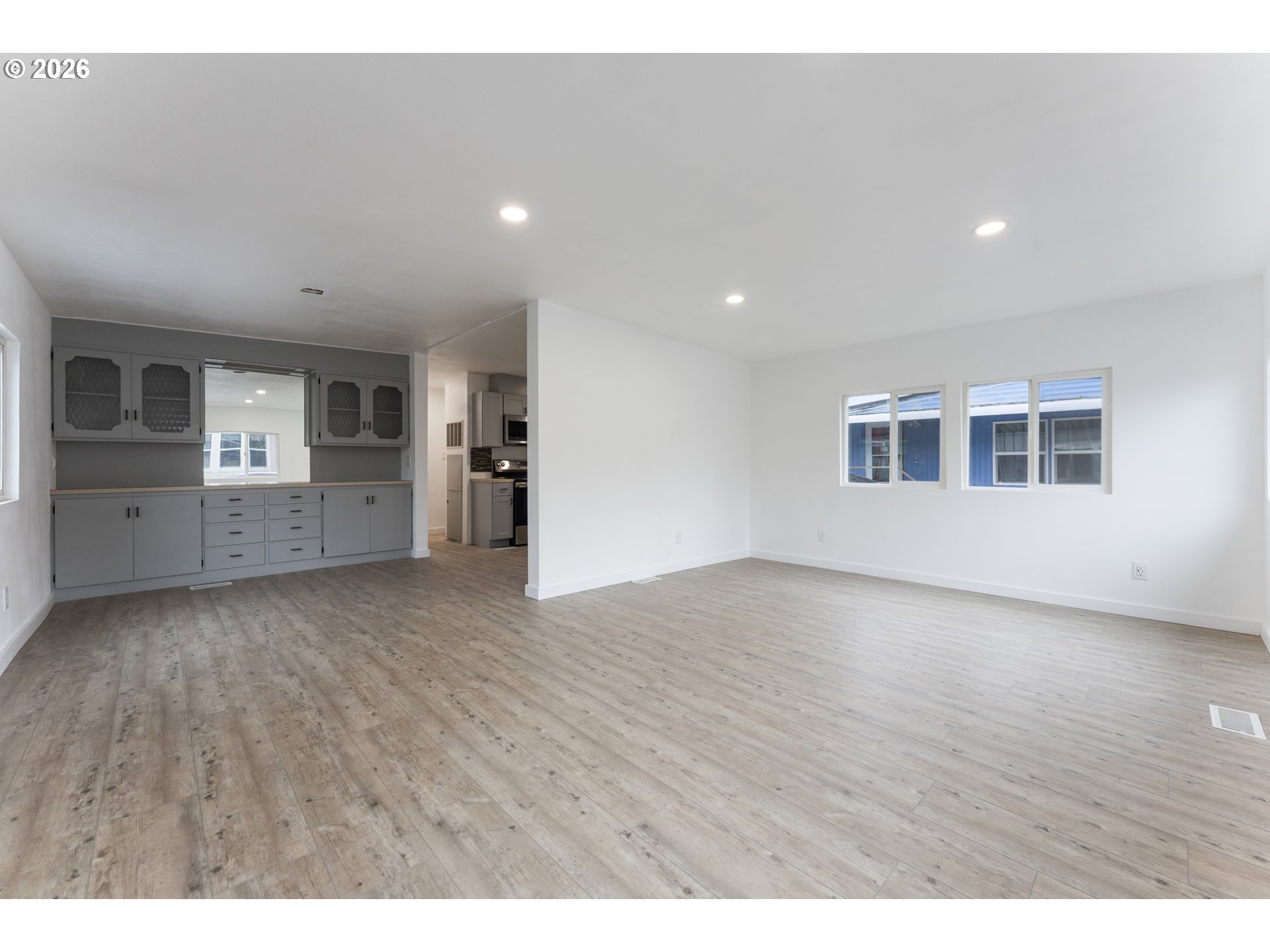 4424 Southeast Roethe Road, Unit 3 Milwaukie, OR 97267 - Photo 9 of 30 a view of empty room with wooden floor and windows