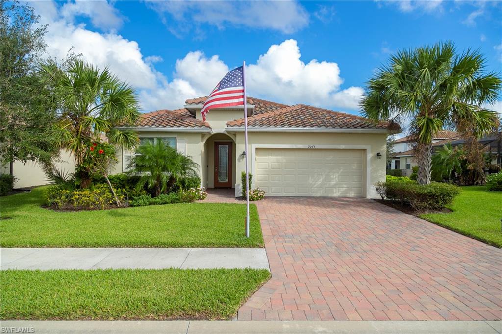 2075 Parson Street Naples, FL 34120 - Photo 1 of 15 a view of a white house with a yard and potted plants