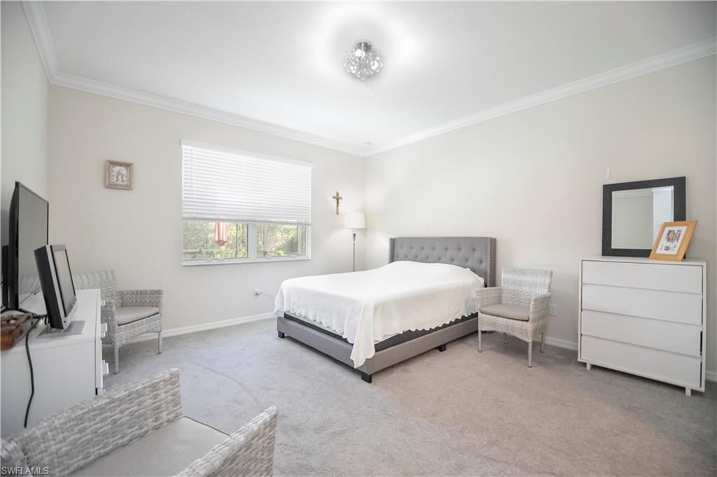 2075 Parson Street Naples, FL 34120 - Photo 11 of 15 a bedroom with a bed lamp on desk and a window