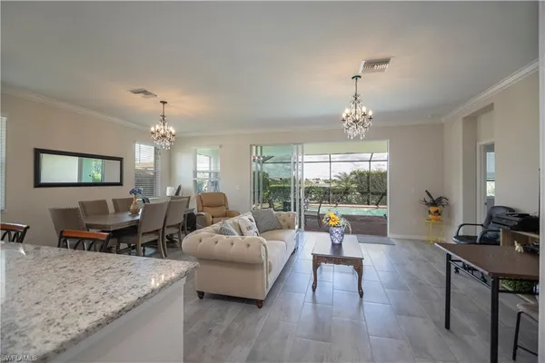 a living room with furniture and a chandelier