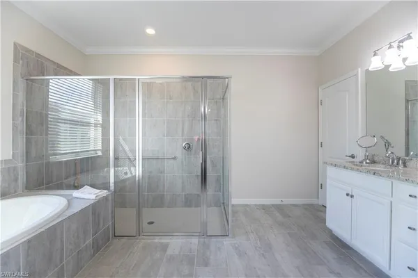 a bathroom with a granite countertop sink a toilet and shower