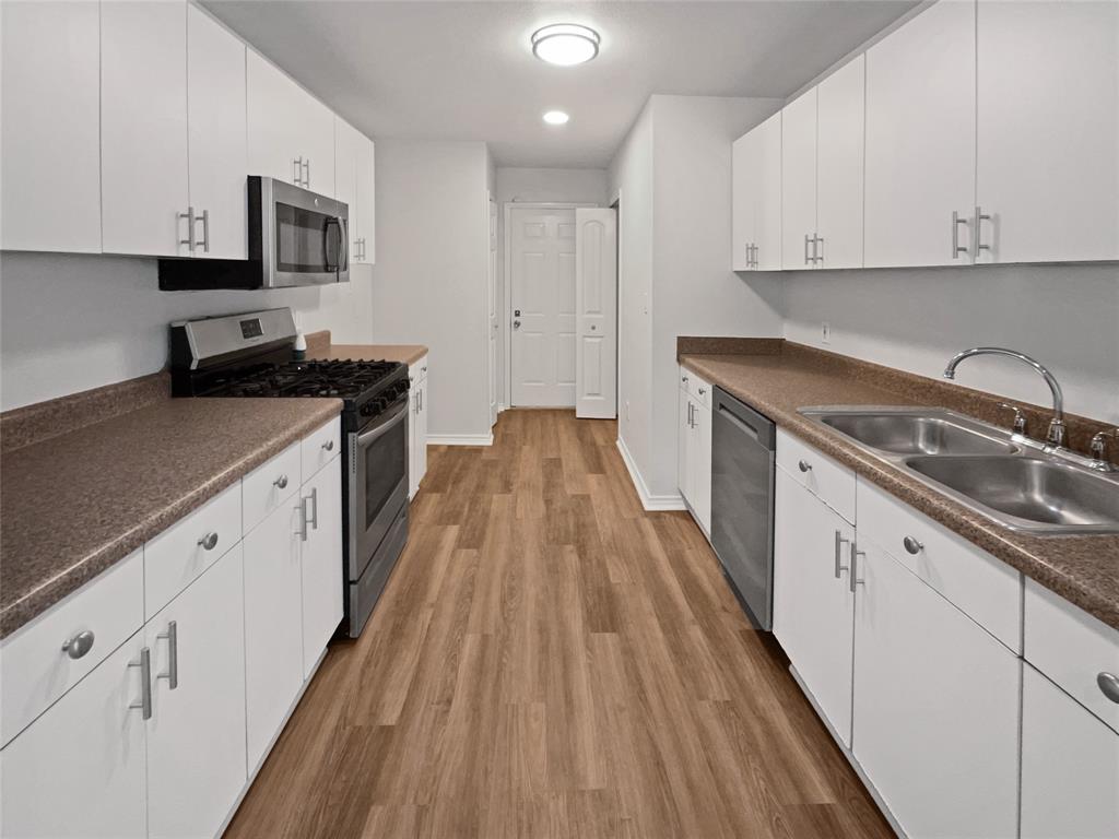 4346 Hamilton Avenue Dallas, TX 75210 - Photo 2 of 16 a kitchen with cabinets appliances and a sink