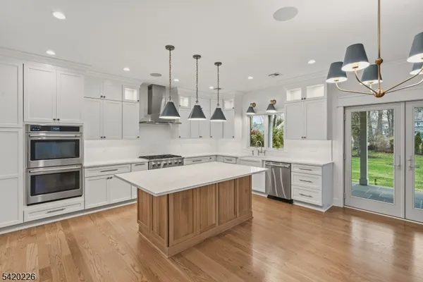 a kitchen with a sink stove and refrigerator