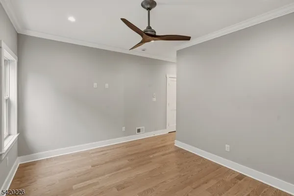 a view of entryway with wooden floor and stairs