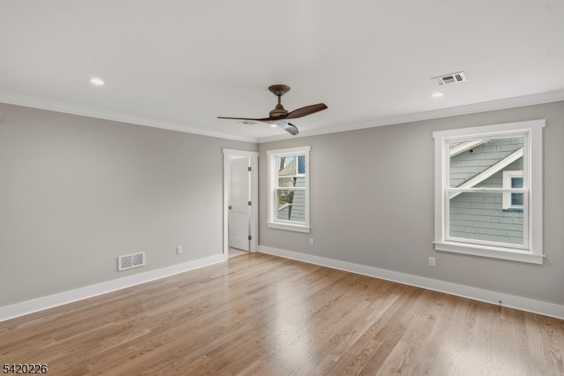 732 Embree Crescent Westfield, NJ 07090 - Photo 17 of 47 a view of an empty room with wooden floor and a window
