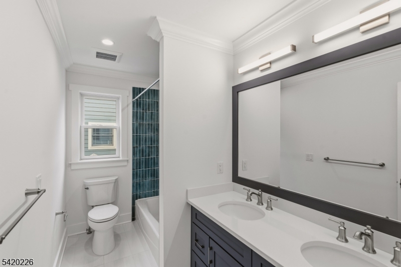 732 Embree Crescent Westfield, NJ 07090 - Photo 18 of 47 a bathroom with a toilet a sink and mirror