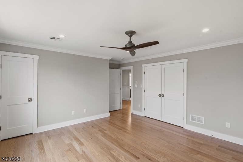 732 Embree Crescent Westfield, NJ 07090 - Photo 19 of 47 a view of room with wooden floor and ceiling fan