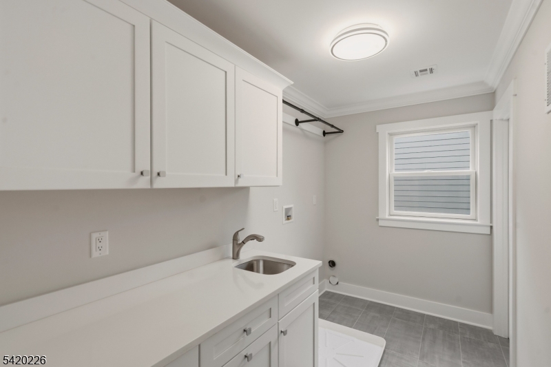 732 Embree Crescent Westfield, NJ 07090 - Photo 21 of 47 a kitchen with a sink cabinets and a window