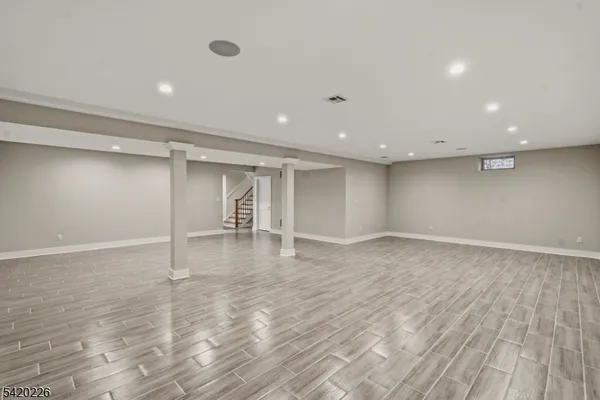 a view of an empty room with wooden floor