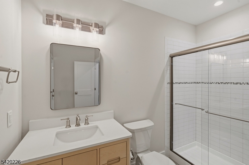 732 Embree Crescent Westfield, NJ 07090 - Photo 37 of 47 a bathroom with a sink toilet a mirror and shower