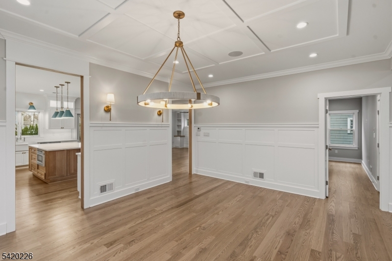 732 Embree Crescent Westfield, NJ 07090 - Photo 6 of 47 a view of a room with wooden floor a ceiling fan and windows