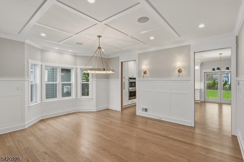732 Embree Crescent Westfield, NJ 07090 - Photo 7 of 47 a view of an empty room with wooden floor and a kitchen