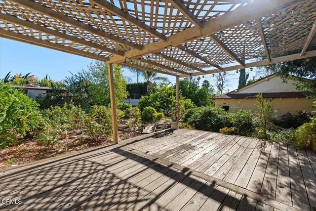 a patio with water fountain and lots of green space