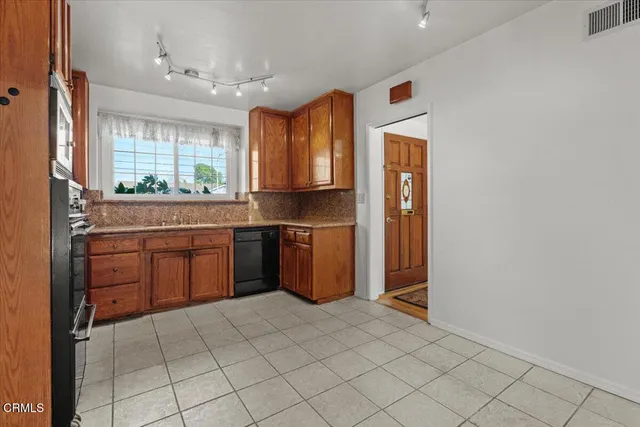 a kitchen with a stove a sink and a refrigerator