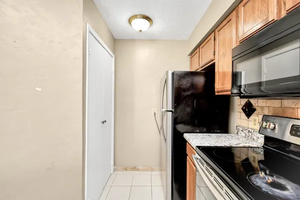 a kitchen with a refrigerator and a stove