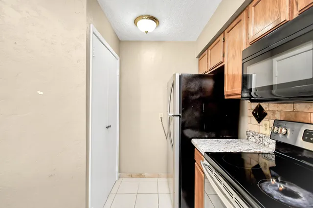 a kitchen with a refrigerator and a stove
