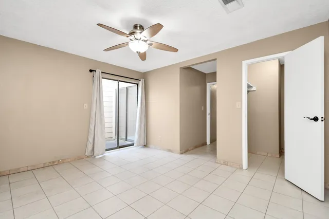 a view of a livingroom with a ceiling fan and window